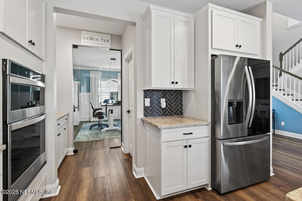 240 Ranch Land Circle St. Johns, FL 32259 - Photo 14 of 117 a kitchen with stainless steel appliances a refrigerator sink and cabinets