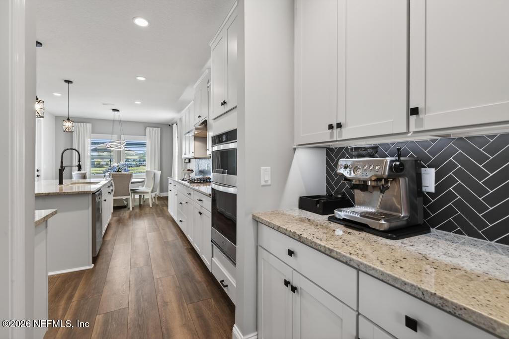 240 Ranch Land Circle St. Johns, FL 32259 - Photo 16 of 117 a kitchen with stainless steel appliances granite countertop a stove a sink and a refrigerator