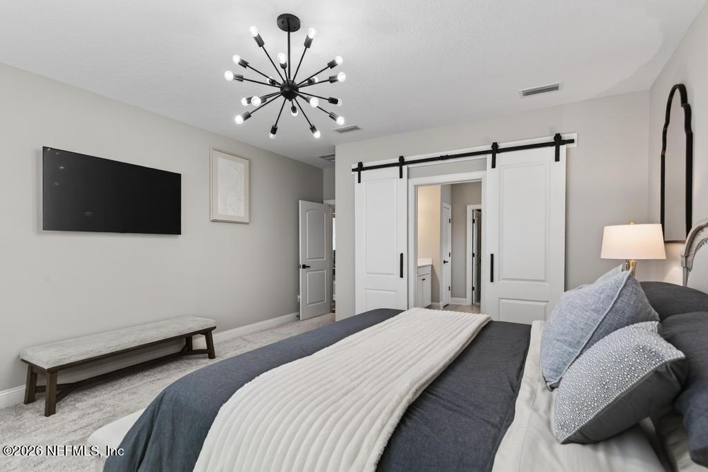 240 Ranch Land Circle St. Johns, FL 32259 - Photo 25 of 117 a bedroom with a bed a tv and wooden floor