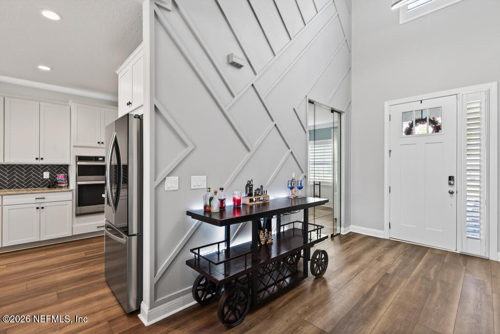 240 Ranch Land Circle St. Johns, FL 32259 - Photo 30 of 117 a view of entryway dining room and hall with wooden floor