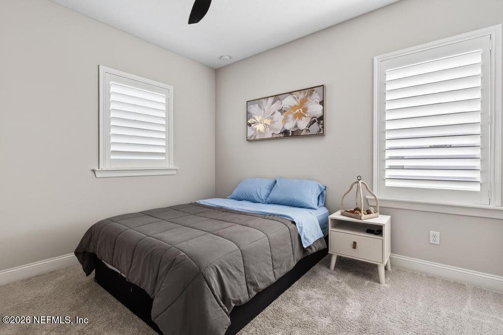 240 Ranch Land Circle St. Johns, FL 32259 - Photo 48 of 117 a bedroom with a bed a dresser and a window