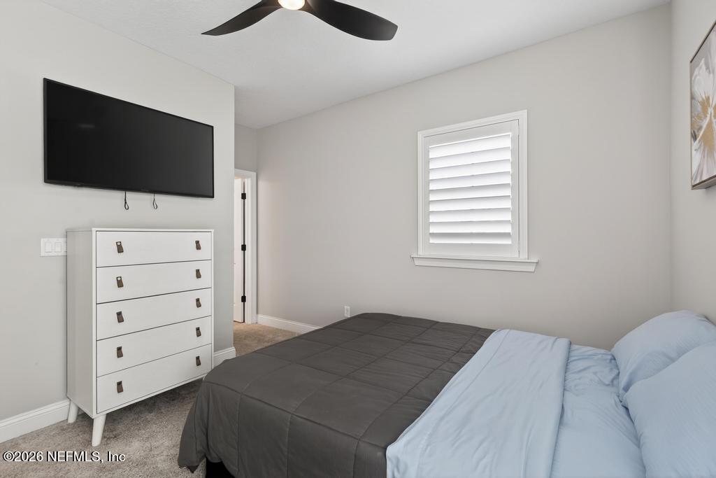 240 Ranch Land Circle St. Johns, FL 32259 - Photo 49 of 117 a bedroom with a bed and a flat screen tv