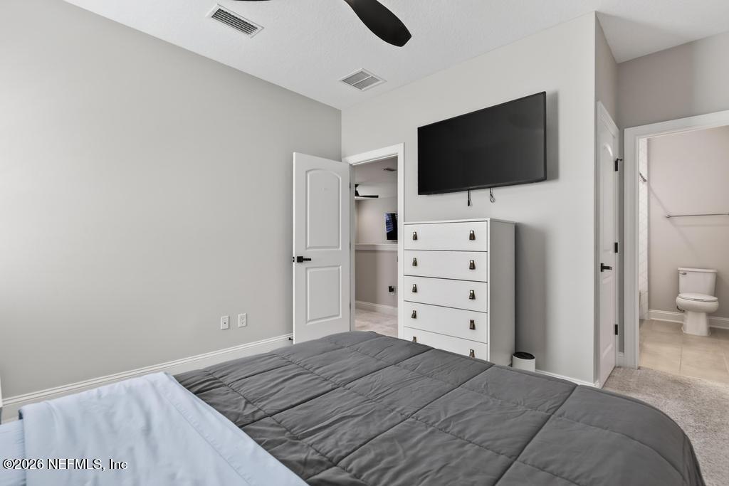 240 Ranch Land Circle St. Johns, FL 32259 - Photo 50 of 117 a bedroom with a flat screen tv on wall and a flat screen tv