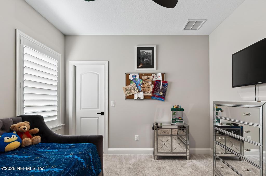 240 Ranch Land Circle St. Johns, FL 32259 - Photo 53 of 117 a bedroom with furniture and a window