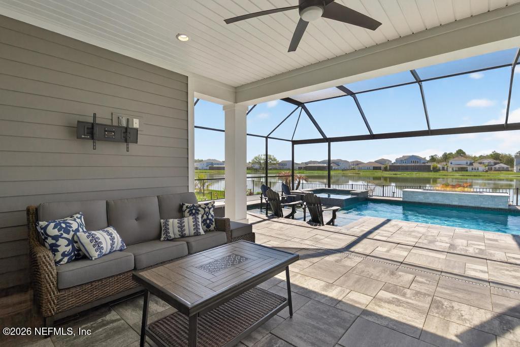 240 Ranch Land Circle St. Johns, FL 32259 - Photo 58 of 117 a living room with fireplace furniture and a floor to ceiling window
