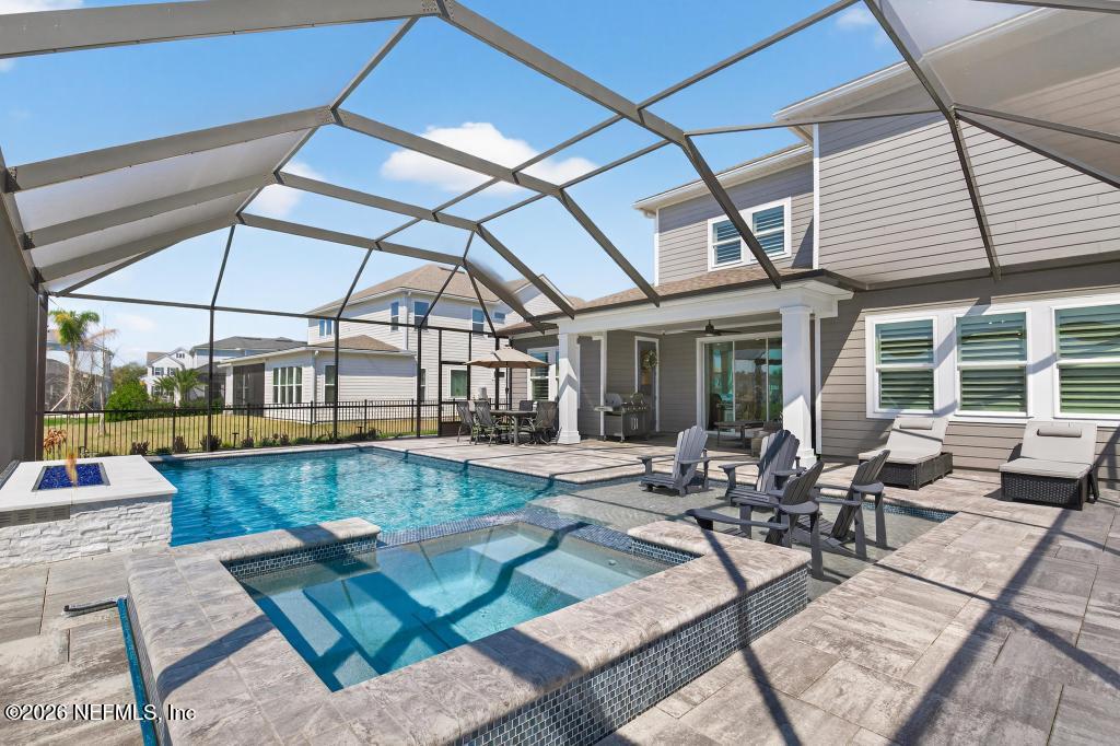 240 Ranch Land Circle St. Johns, FL 32259 - Photo 66 of 117 a view of a patio with couches table and chairs under an umbrella