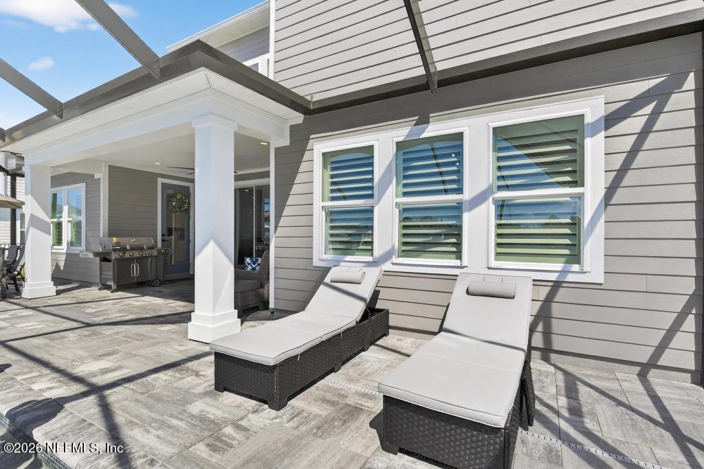 240 Ranch Land Circle St. Johns, FL 32259 - Photo 67 of 117 a view of a patio with a table and chairs