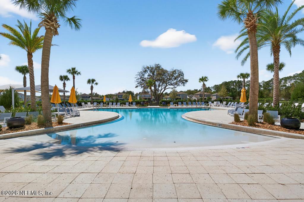 240 Ranch Land Circle St. Johns, FL 32259 - Photo 91 of 117 a view of a swimming pool with a table and chairs