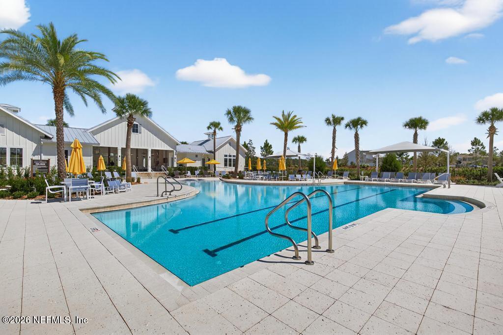 240 Ranch Land Circle St. Johns, FL 32259 - Photo 94 of 117 a view of swimming pool with outdoor seating and a potted plant