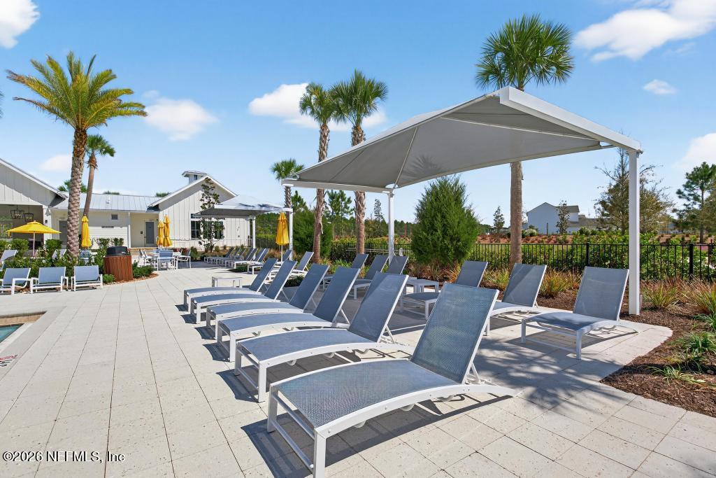 240 Ranch Land Circle St. Johns, FL 32259 - Photo 96 of 117 a view of a patio with a table and chairs under an umbrella