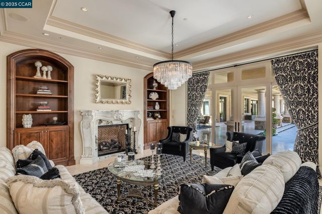 a view of a dining room with furniture and chandelier