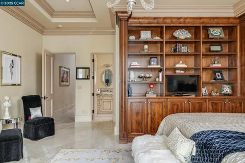 a bedroom with a bed a couch and a window