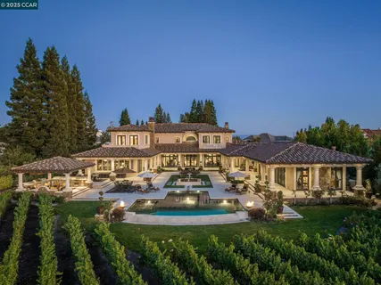 a view of a house with garden space and sitting area
