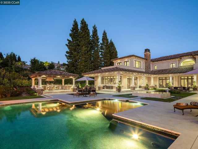 a view of an ocean with swimming pool and lounge chairs