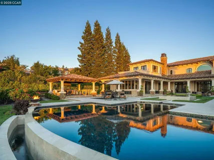 a front view of a house with swimming pool having outdoor seating