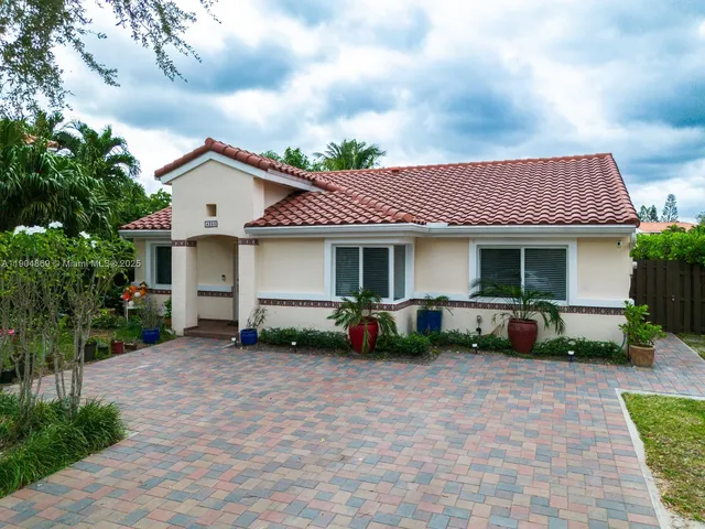 a front view of a house with a yard and outdoor seating