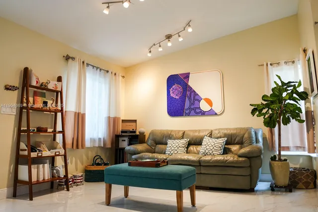 a living room with furniture and a large window
