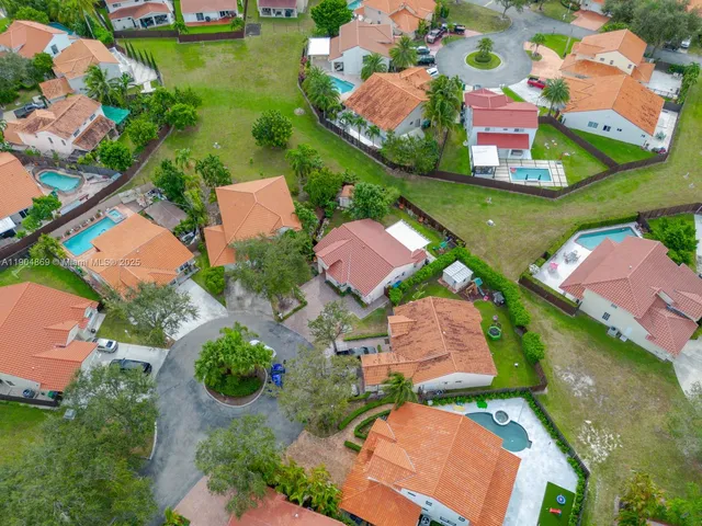 an aerial view of residential houses with outdoor space and street view