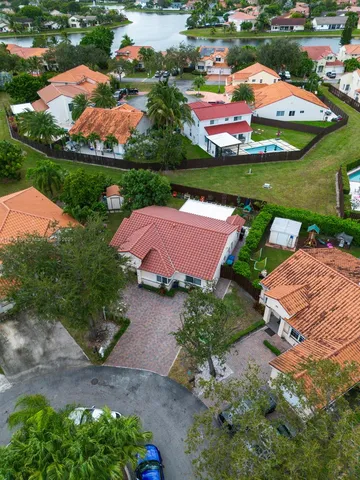 an aerial view of a swimming pool patio and outdoor seating