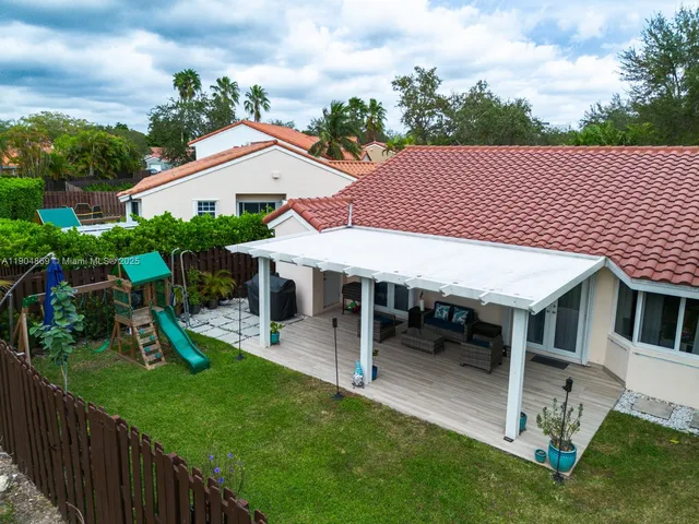 a view of a house with a yard patio and a garden