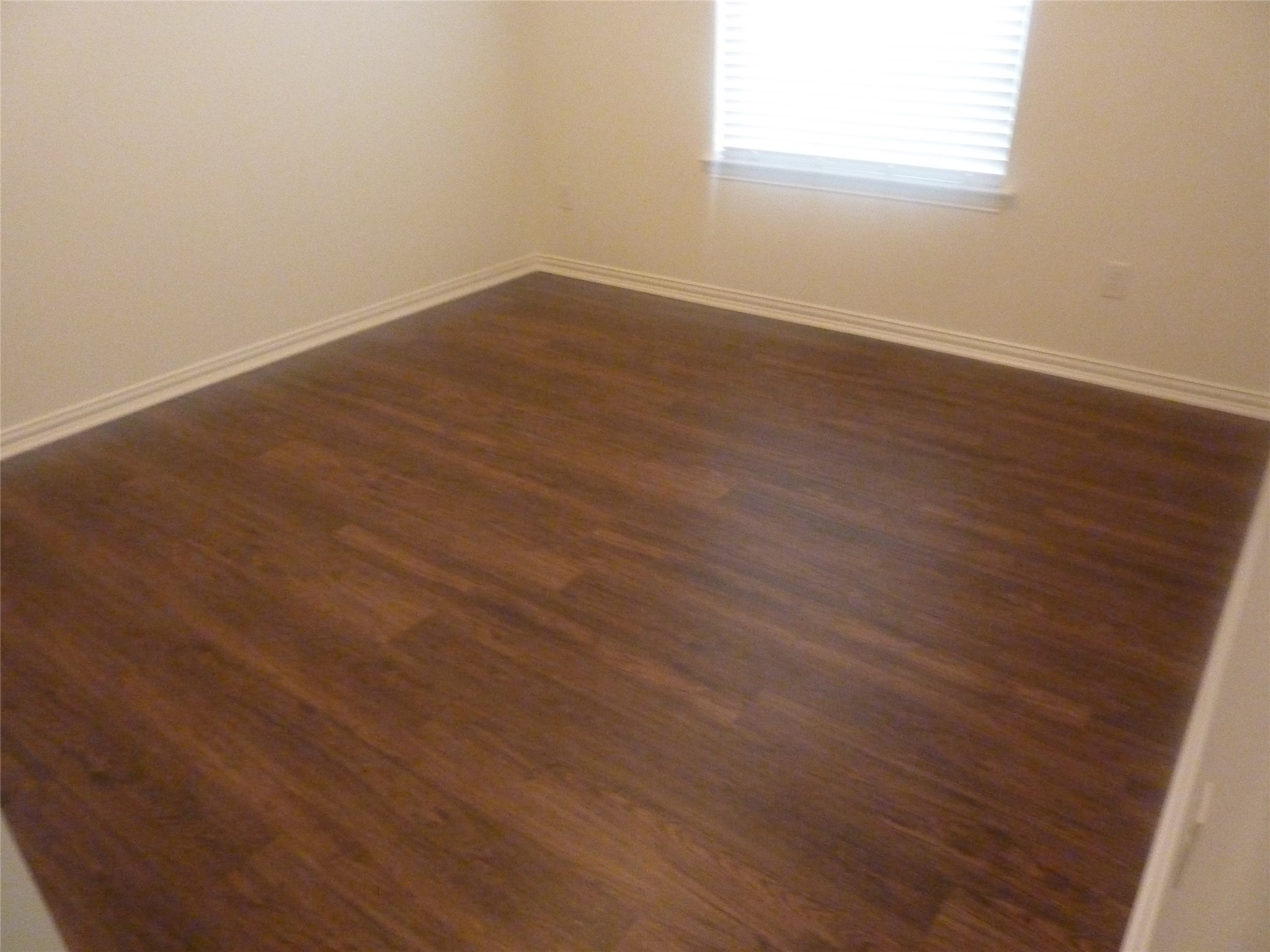 24038 Clipper Hill Lane Spring, TX 77373 - Photo 9 of 14 an empty room with wooden floor and windows