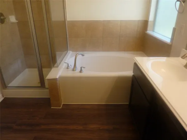 a bathroom with a bathtub and a sink