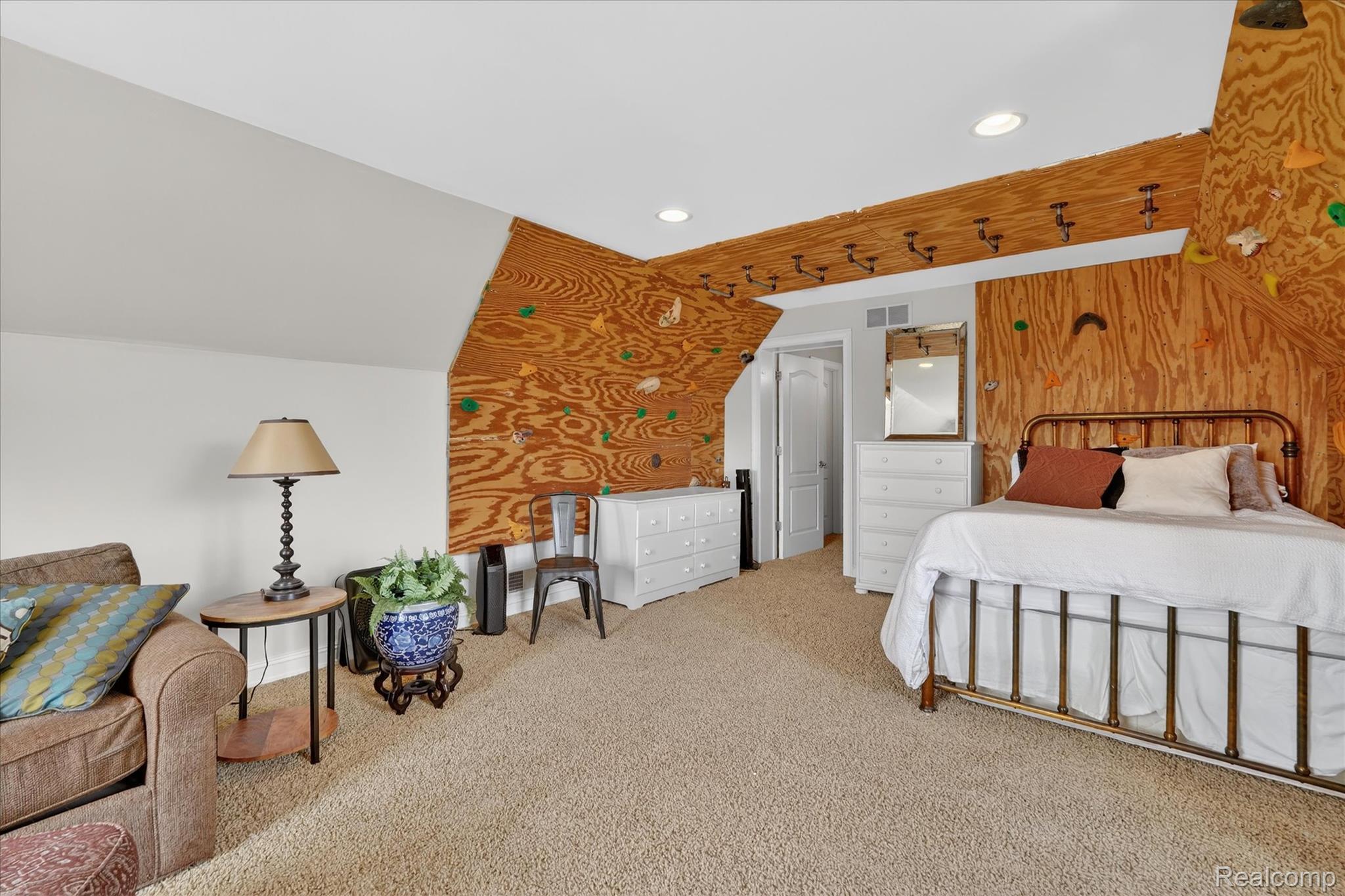 6932 Oakhurst Ridge Road Clarkston, MI 48348 - Photo 36 of 78 Carpeted bedroom featuring wooden walls, recessed lighting, and an accent wall