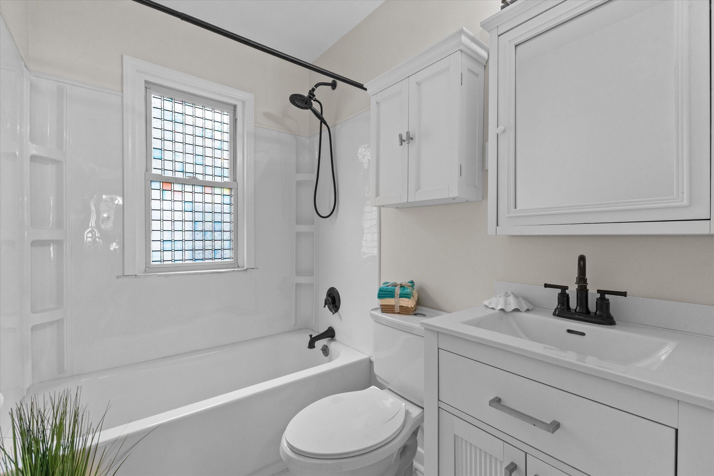 1905 Gilson Street Racine, WI 53403 - Photo 6 of 13 Bright full bathroom features an updated vanity, modern fixtures and a tub/shower combination.