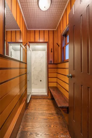 a view of a porch with wooden floor and fence