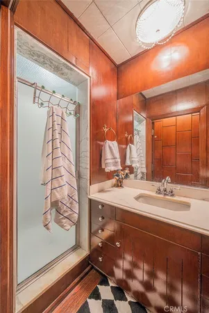 a bathroom with a double vanity sink mirror and shower