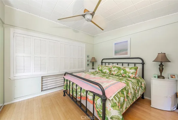 a bedroom with a bed a baby crib and a window