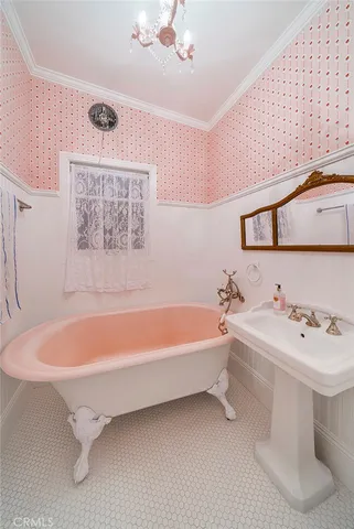 a bathroom with a white tub a sink and a mirror
