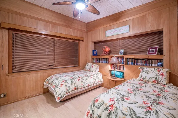 a bedroom with two beds and a chandelier