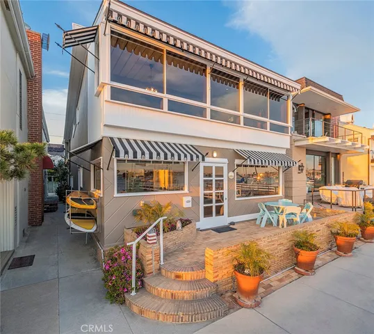 a front view of a house with outdoor seating