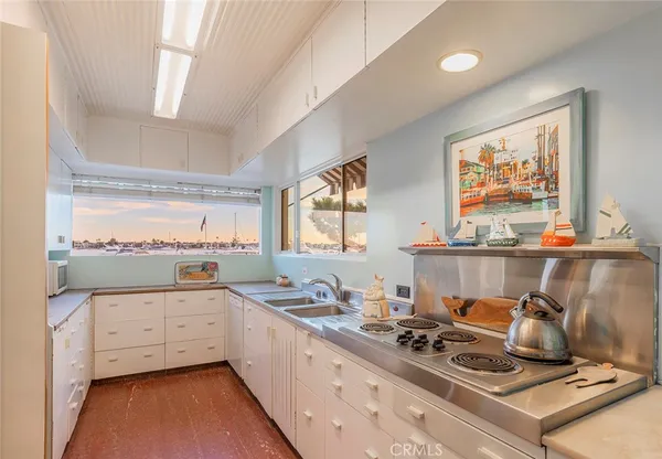 a kitchen with a stove a sink and a refrigerator