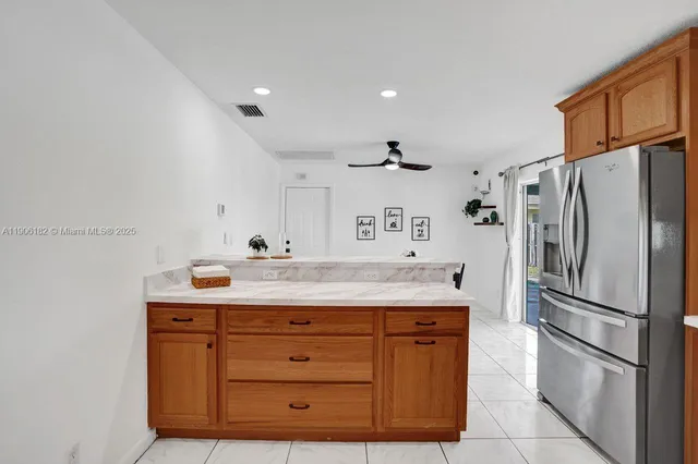 a kitchen with stainless steel appliances a refrigerator and a stove top oven