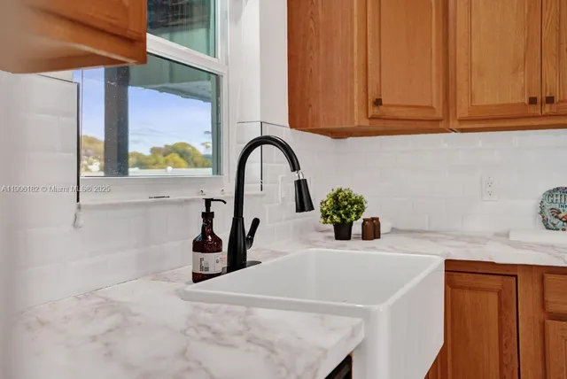 a dining room with furniture a chandelier and window