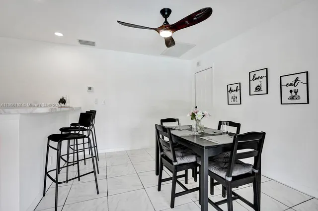 a bedroom with a bed next to a window with wooden floor