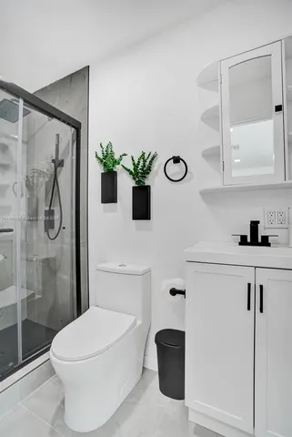 a white bath tub sitting next to a white cabinet