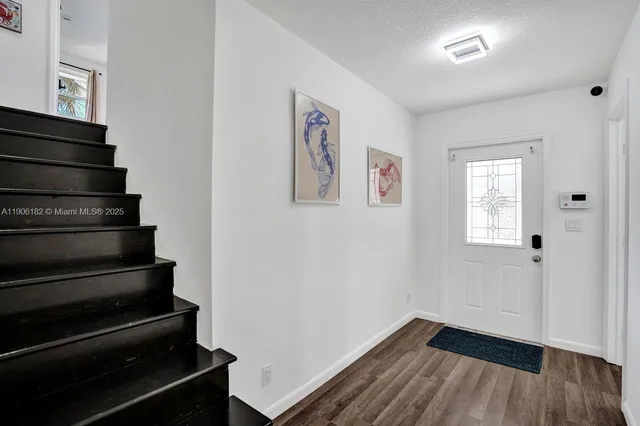 a kitchen with stainless steel appliances granite countertop a refrigerator sink and stove