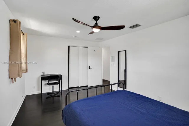 a view of a hallway with wooden floor and entryway