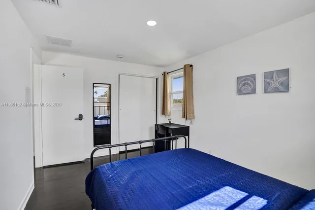 a view of a lake with a yard and potted plants