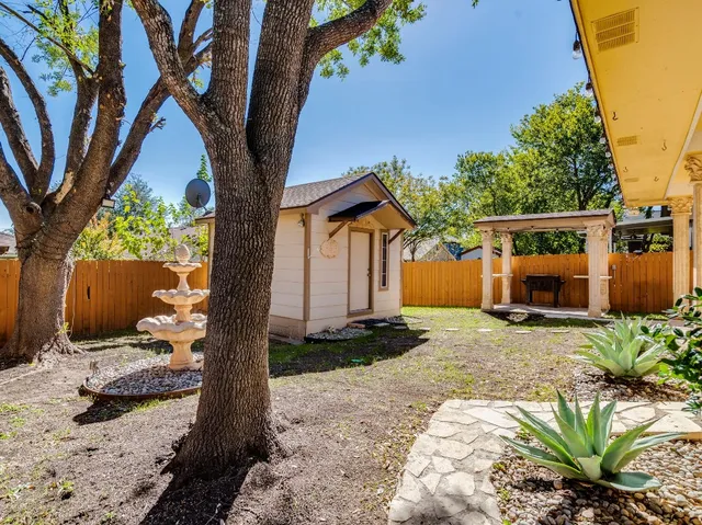 a view of a house with a tree in the background