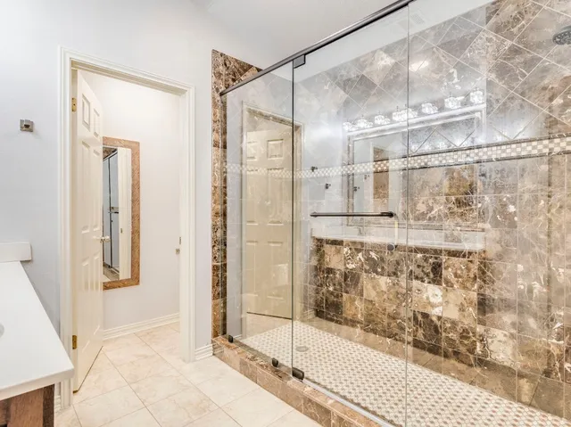 a bathroom with a glass shower door