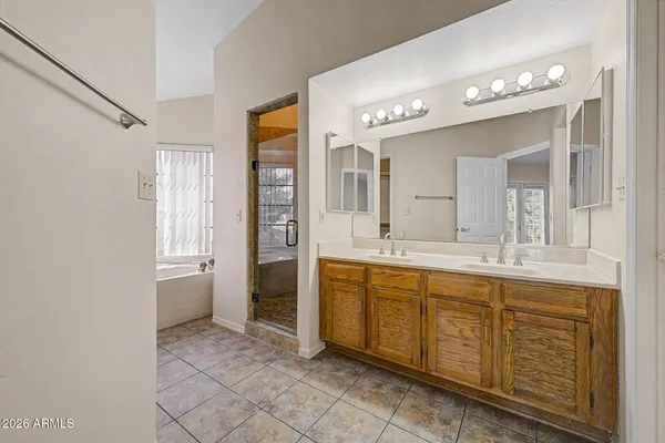 a spacious bathroom with a granite countertop sink mirror and a
