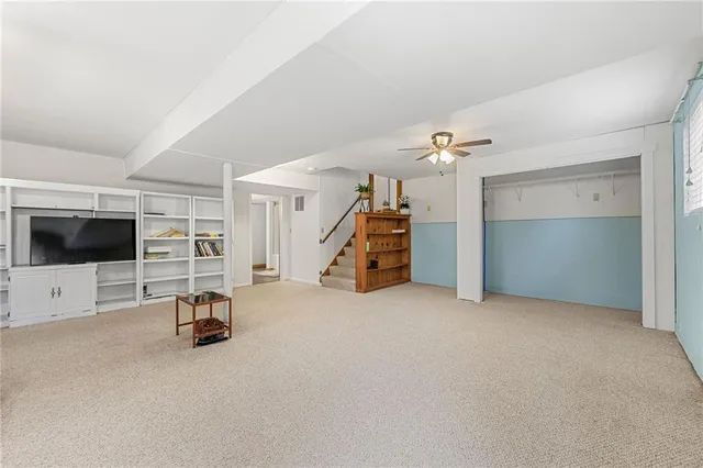 a view of a livingroom with gym equipment and a flat screen tv