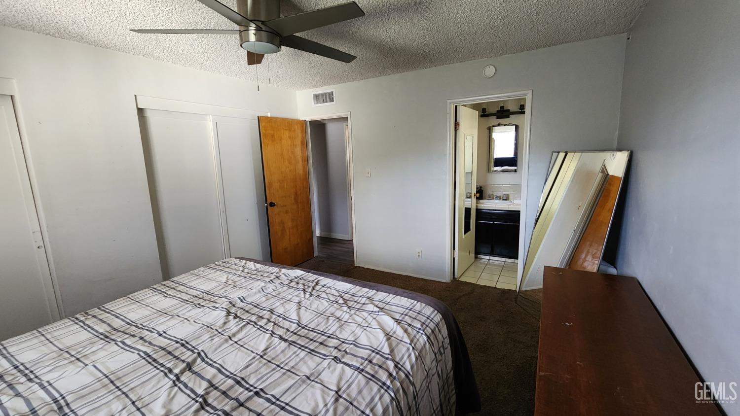 Undisclosed Address Bakersfield, CA 93306 - Photo 11 of 22 a bedroom with a bed and a mirror