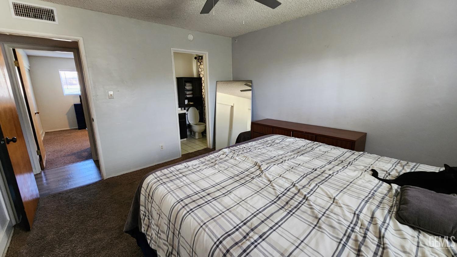 Undisclosed Address Bakersfield, CA 93306 - Photo 12 of 22 a bedroom with a bed and wooden floor