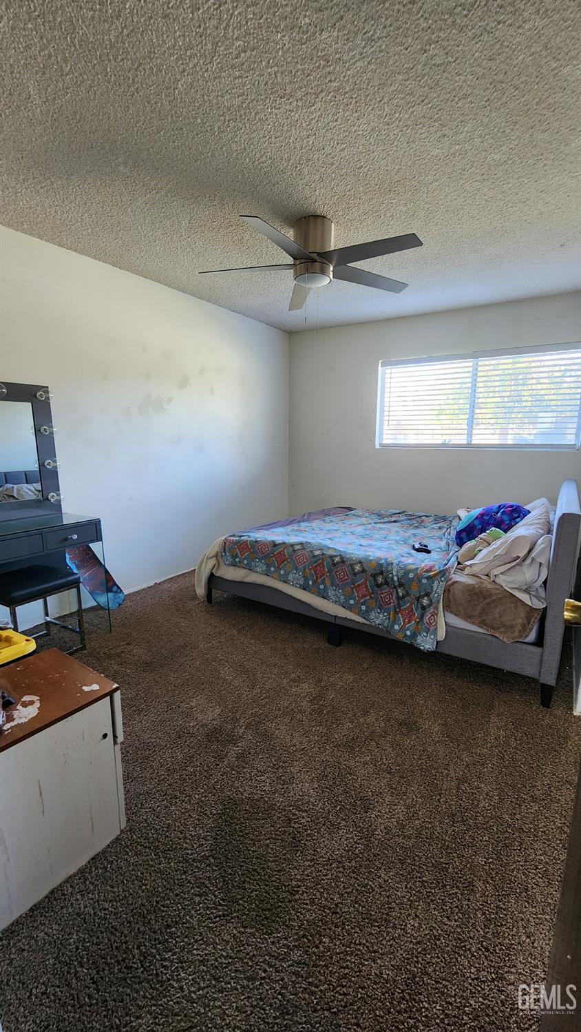 Undisclosed Address Bakersfield, CA 93306 - Photo 14 of 22 a bedroom with a bed and a window