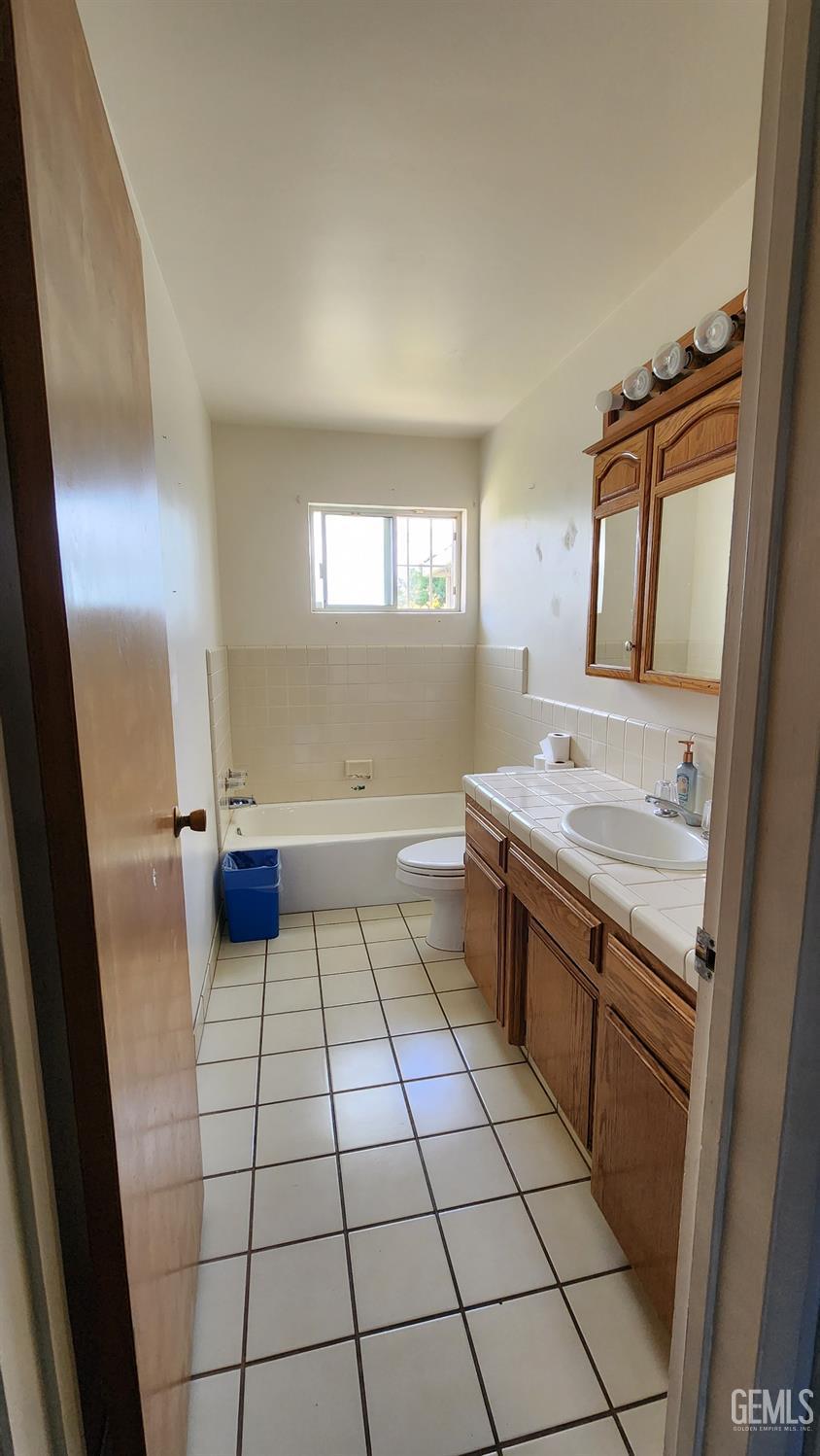 Undisclosed Address Bakersfield, CA 93306 - Photo 15 of 22 a bathroom with a sink a toilet and mirror